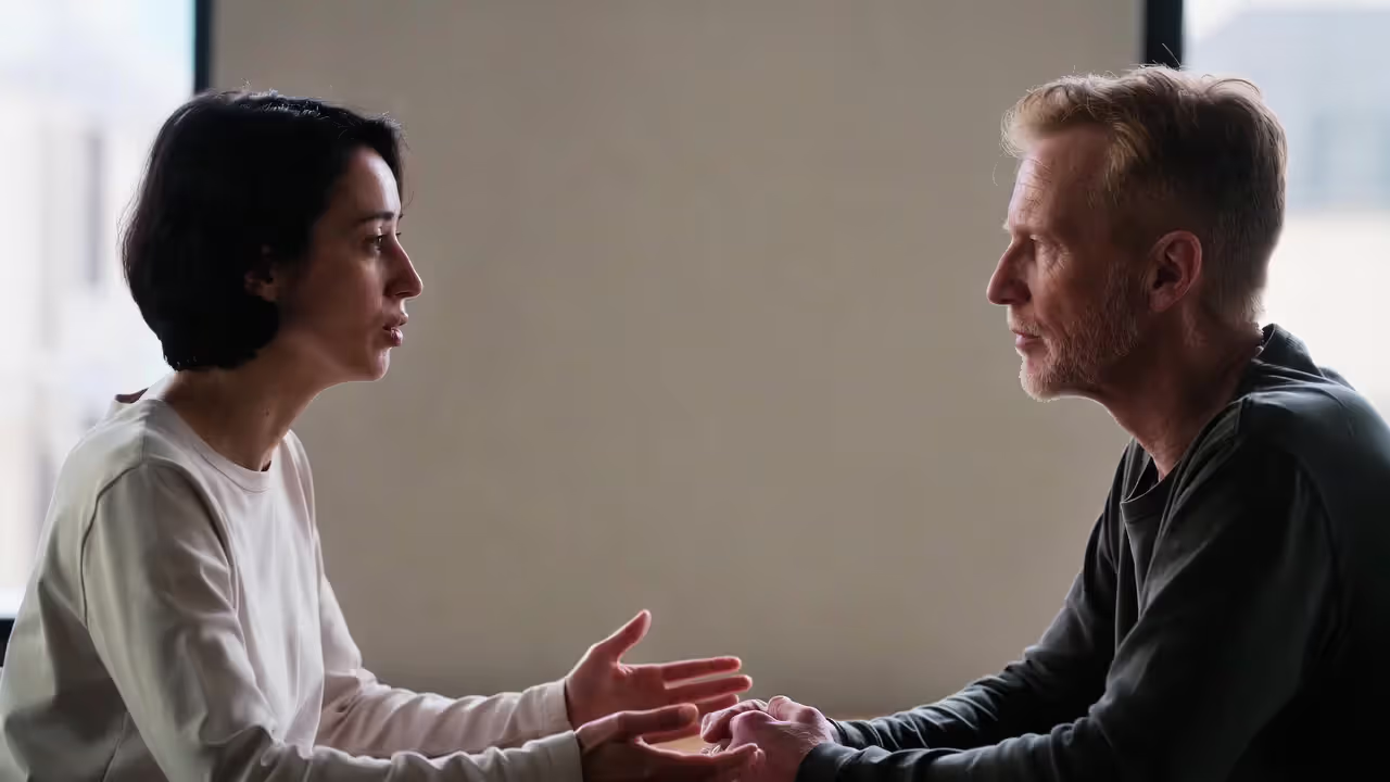 Two adults having calm face-to-face conversation with open body language